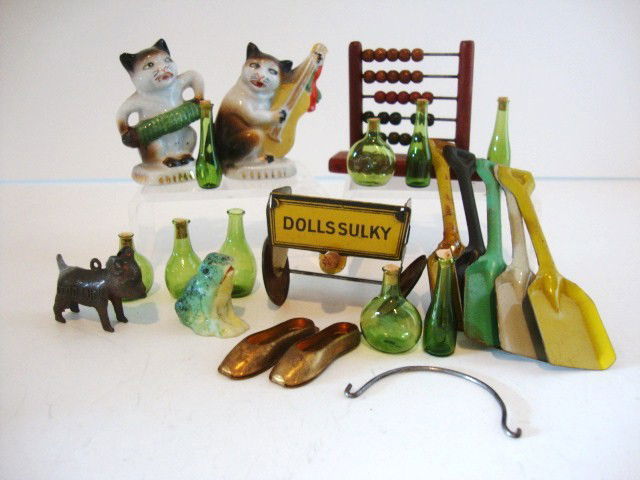 Dollhouse Accessories and Cracker Jack Toy: Dolly Sulky Cracker Jack tag, bottles, tin shovels, cat figures, abacus, approximately 15 pcs, 2" tallest.