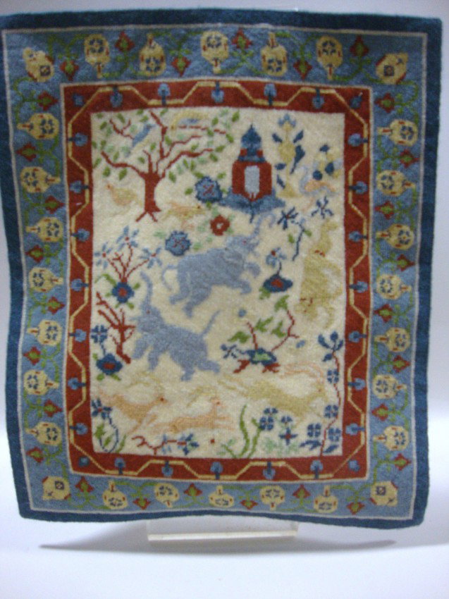Pictorial Needlepoint Dollhouse Rug: Multi-bordered oriental dollhouse rug in tight shaft needlepoint with elephants and deer, red floral border interior, blue border on edge with urns and flowers 12 x 10", one of the best examples of ru