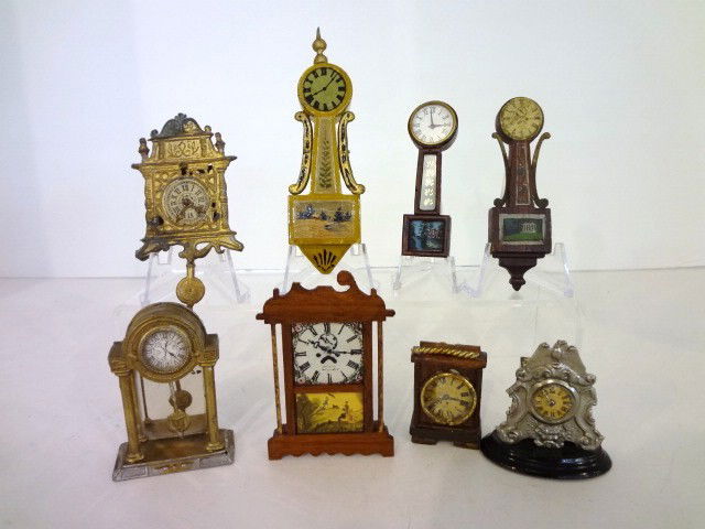 Assortment of Clocks: Eight antique and vintage clocks inlcuding two Tynietoy banjo clocks (one missing finial), a Chestnut Hill Terry clock (damaged) and miscellaneous wooden and metal examples. Tallest 4.25" H.