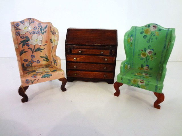 Tynietoy Wing Chairs: A pair of pretty vintage Tynietoy painted wing chairs 5" H. The pink has an old repair to one leg and areas of paint loss, the green has a clean split on the front apron. Also a Tynietoy Winthrop desk