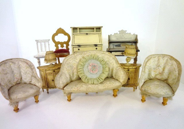 Lot of Antique German Dollhouse Furniture: A larger scale upholstered parlor suite with settee 7.5" L, two matching chairs and an assortment of additional items including painted desk (one drawer missing), chair, two consoles with carved bone 
