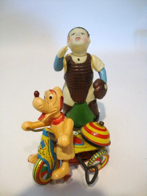 Pluto and Baseball Player Wind-up Toys: Celluloid Baseball Catcher Wind-up, approximately 6" (t), Occupied Japan & Pluto on tricycle wind-up, Celluloid Pluto & tin tricycle by Linemar, marked Walt Disney & co., 4" (t)