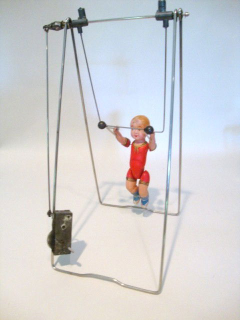 Celluloid Trapeze Wind-up Toy: Celluloid Acrobat on Metal Frame, spins & flips when wound, 13" (t), 1950's Japan