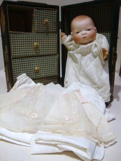 By-Lo Bisque Doll: Grace Storey Putnam 12" Bisque Doll w/cloth body & celluloid stand w/trunk & white clothing accessories, trunk 7" x 12" x 7"