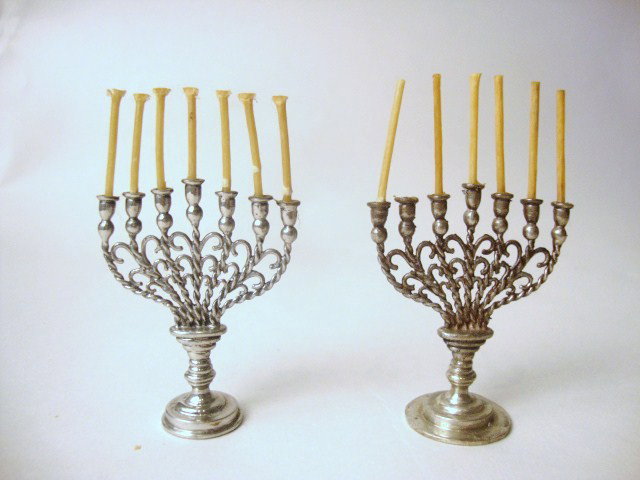 Meyers Pair of Menorahs: Pair of Meyers menorahs on round stepped base with knopped stem rising to an oval platform, with seven twisted arms supporting tulip- and ball-shaped sockets, the arms are interlinked with scrolled sp