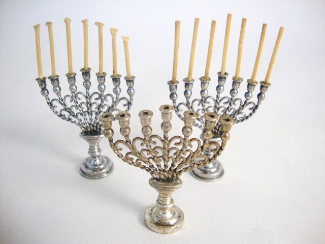 Meyers Three Menorahs: Three menorahs on round stepped base with knopped stem rising to an oval platform, with seven twisted arms supporting tulip- and ball-shaped sockets, the arms are interlinked with scrolled spurs, each