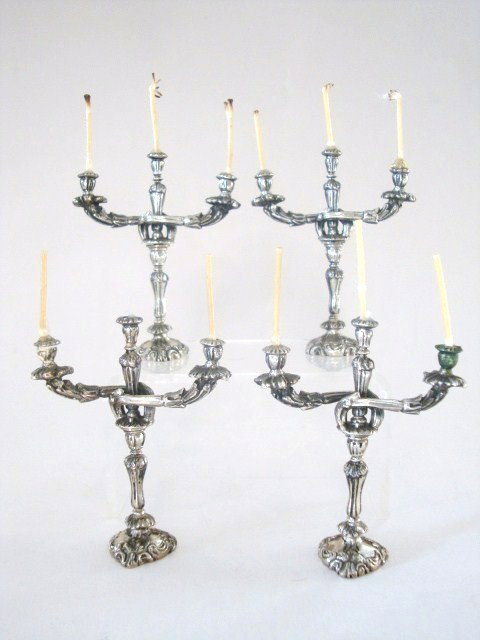 Meyers Two Pair George III Candleabrum: Two pair of George III candleabra after J. Green London 1794. Three lights each with incredible chased bases and fanciful arms. 2.5" H marked "M" Sterling hand made