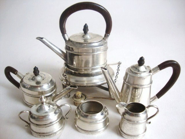 Meyers Tea Set: Six-piece Meyers tea and coffee set, with an oval-bodied kettle on stand, teapot and coffee pot with a similarly formed tapered body, sugar and cream and waste bowl, the stand with four pad feet and b