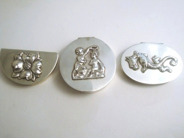 Meyers Sterling Pill Boxes: Three Meyers sterling pill boxes: one demilune floral, circular Cupid, oval serpent, 2" largest, all marked "M" Sterling handmade