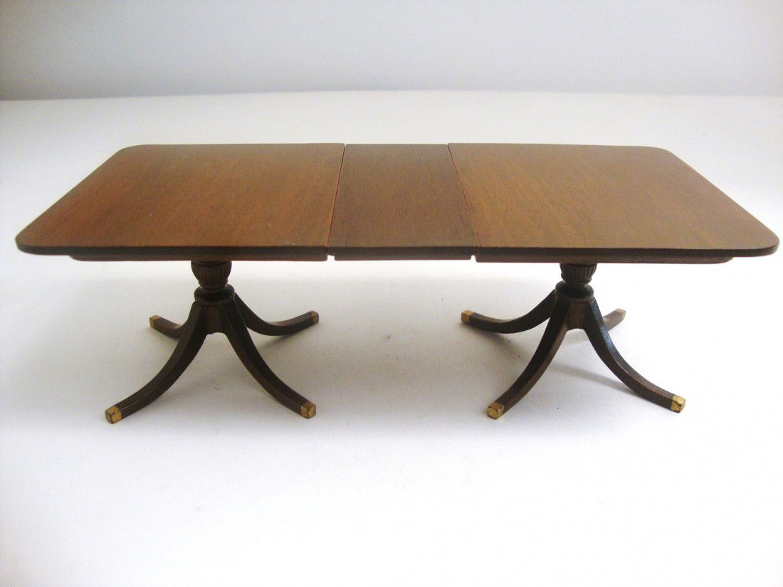 Eric Pearson Dining Table: Classic mahogany Duncan Phyfe extending dining table with one leaf, two reeded pedestal bases, beautifully finished. One end of the table top has small scratches. With leaf, it measures 7.5" L, 2.5" H