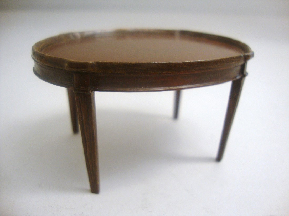 Eric Pearson Oval Coffee Table: Hepplewhite style mahogany oval tea table with fluted tapered legs and delicately carved tabletop rim with a few tiny nicks that may date to its manufacture. 2.5" L, 1.5" H, 1.75" W..