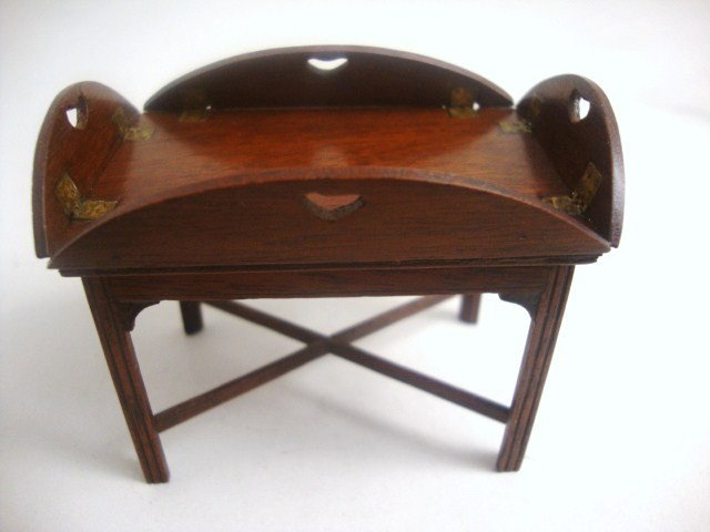 Eric Pearson Butler: Classic mahogany Chippendale butler's tray with hinged and pierced folding sides, lifts off from braced base. 2.5" L, 2" H, 1.75" W.