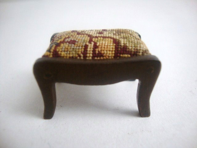 Eric Pearson Petipoint Footstool: Small mahogany footstool upholstered with antique petipoint embroidery. 1" L, 3/4" H and D.