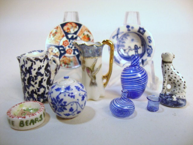 Artisan Pottery: An assortment of pottery by various artisans including Debbie McKnight, Nancy Dudek, and Carolyn Curran, mostly blue and white. Spotted dog figurine 1" H. Also three pieces of striped glass.