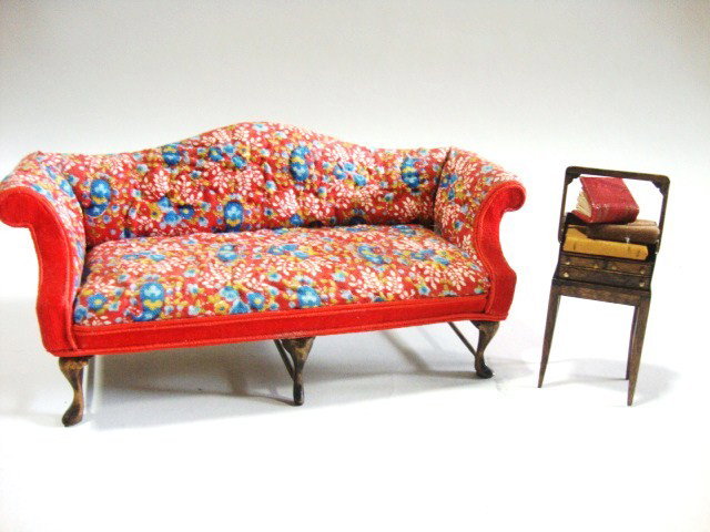 Judee Williamson Sofa: A colorful camelback sofa upholstered in quilted cotton 6.75" L and a mahogany tantalus or book carrier with stand by Terry Rogal.