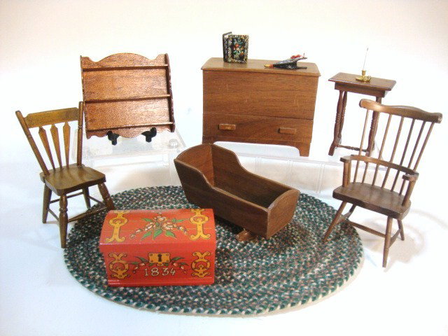 Artisan Country Furniture: A blanket chest 3.5" L and 2.5" H signed by John Barnstead, a wall shelf, cradle, two chairs and a table by Handcraft Designs, a small painted chest and a fine braided rug.