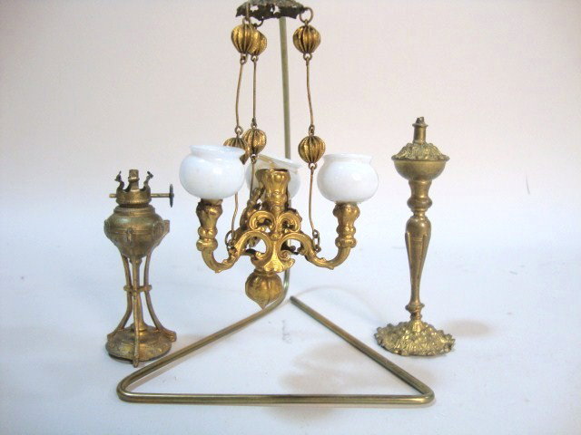Ormolu Three-Arm Gasolier: An ormolu chandelier with three original globes (one damaged and chains shortened) 4.5" H, an ormolu tall kerosene lamp, tarnished with no shade and a gilt metal kerosene lamp with no shade.
