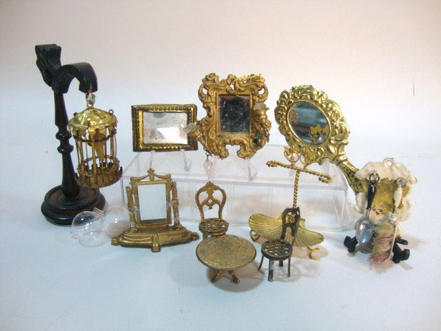 Lot of Gilt Metal Accessories: A painted ormolu brush holder with brush and spoon 2" H, a brass birdcage suspended from a wooden stand, mirrors, and toy chairs and table.