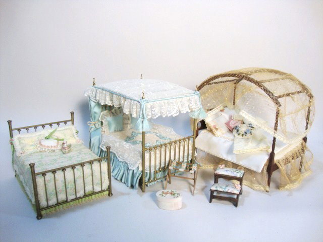 Three Artisan Beds: Two lavishly dressed canopy beds approx. 7" L and H, the brass one marked "by Garnett", a lower brass bed signed "Nancy Jane" and a set of bedsteps.