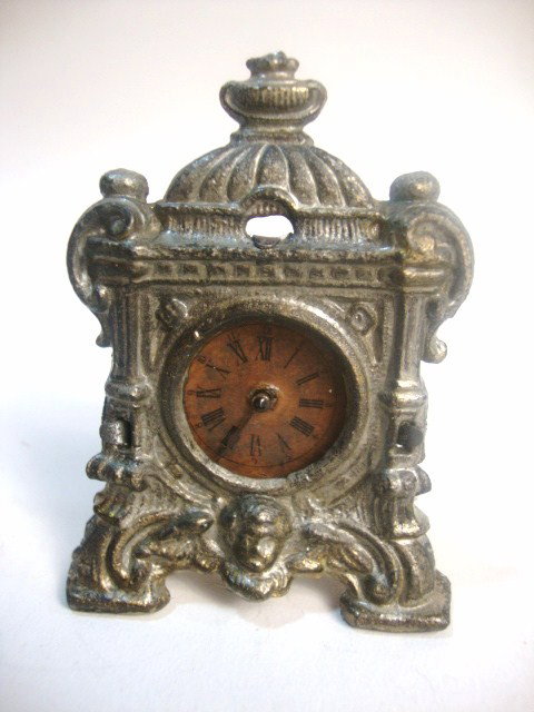 Antique Mantel Clock: Ormolu mantel clock decorated with putti with key wind movement, hands on clock move 3" H