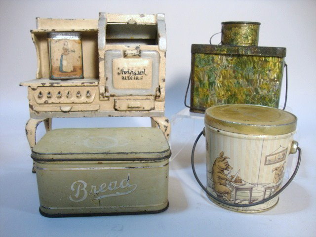 Arcade Cast Iron Stove and Tinware: Arcade Hotpoint cookstove in original cream and green paint, together with tin Three Little Pigs pail, multi-colored lunch pail, bread tin, and small cocoa advertising tin. Great lot! 6.25" H" largest