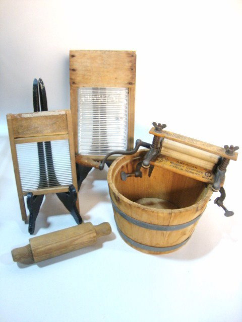 Wooden Wash Tub and Boards: Child-size wooden washtub, two glass-centered washboards, one with Crystal on front, rolling pin, and cast iron and wooden wringer "American Wringer Company New York" 11 3/8" tallest. Crystal washboar