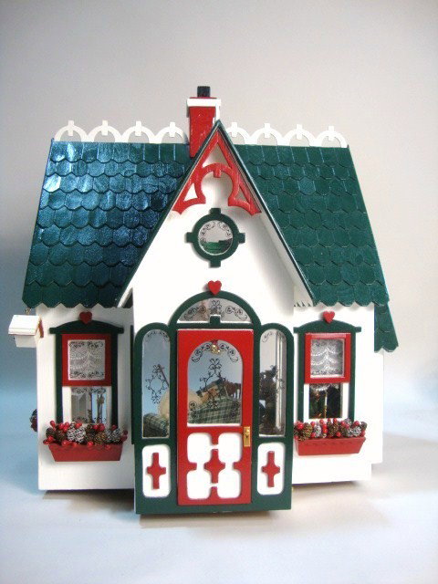Christmas Cottage: A charming little cottage made from a kit and fully decorated for Christmas with a nice needlepoint rug, mainly commercial furniture and accessories. 19.5" H, 17" L, 11.5" D.