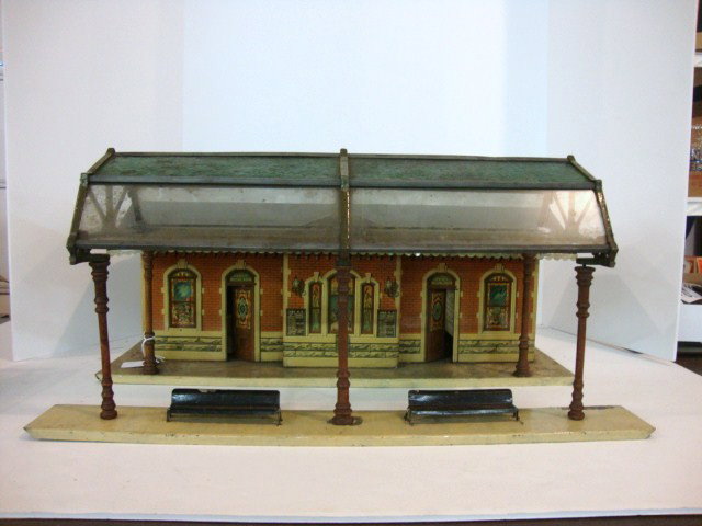 Ives Grand Central Station: Ives Tin Lithographed Grand Central Station, base measures 22" x 10 1/2", Station measures 19 1/2" x 7 3/4" x 9 1/2" to top of chimney, has people lithographed in windows along with Ives R.R. train sc