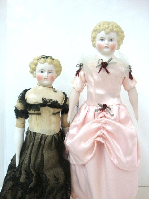 Two Parian Head Dolls: Beautiful 20" Parian Head, Blue Painted Eyes, Black Bow in Her Hair, Cloth Body, Leather Feet, Replaced Arms, Repaired Shoulder Plate And 20" Parian, Blond Curls, Painted Blue Eyes, All New Body