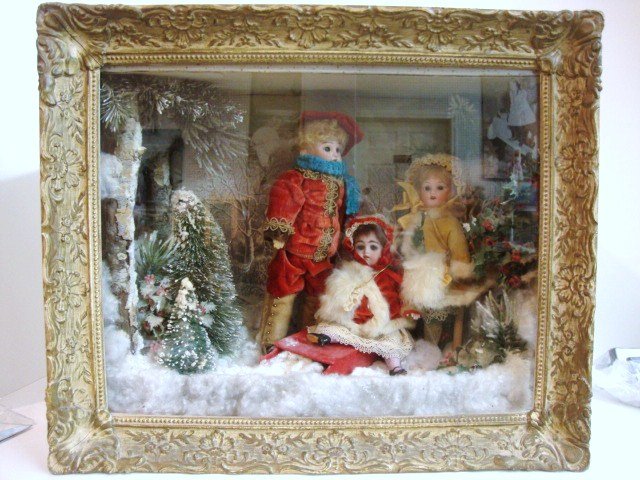 Gold Edged Shadow Box with Dolls in Winter Scene: Three Dolls in Winter Scene in Gold Edged Shadow Box: 10.5" German Bisque head by Armand Marseille on ball jointed composition body w/straight wrists, brown sleep eyes, head marked AM 1894, dressed as
