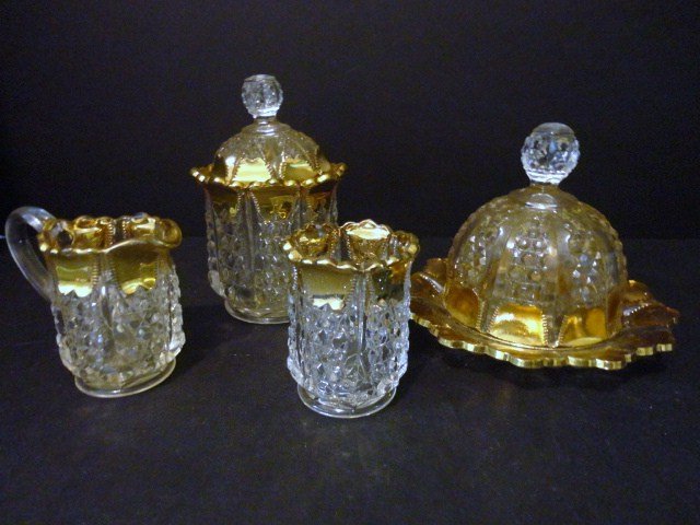 Button Panel Table Set: Four piece Button Panel gold Ribbed Table Set:reamer, Covered Sugar, Spooner, Covered Butter 4 7/8" H.