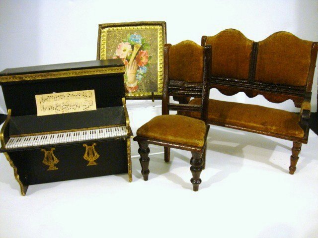 Antique Candy Container Piano: A cardboard candy container in the form of an upright piano 4" H and W, (slight loss to one side and back), a naïve settee and matching chair made from cigar box wood, both 5" H with some repairs, an