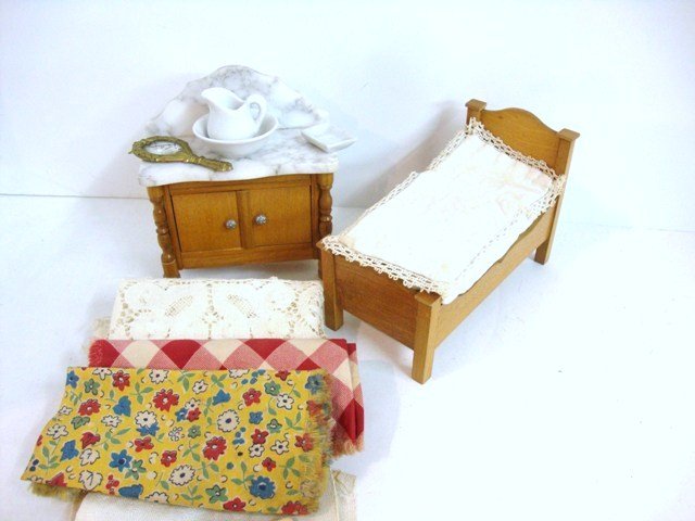 Schneegass Bedroom Furniture: A small bed 5"L, 2.5" W and 3.5" H with an assortment of bedding and linens, a marble-topped washstand (slight scratches to marble) with a brass hand mirror (some loss to silvering), white ironstone p
