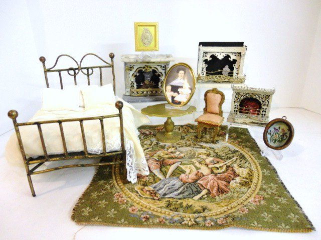 Antique Fireplaces: Three small antique fireplaces ranging in condition, largest 4" L, 3.5" H with a tapestry rug, antique table and chair, some pictures and a vintage metal bed 7" L, 6" H, 5" W.