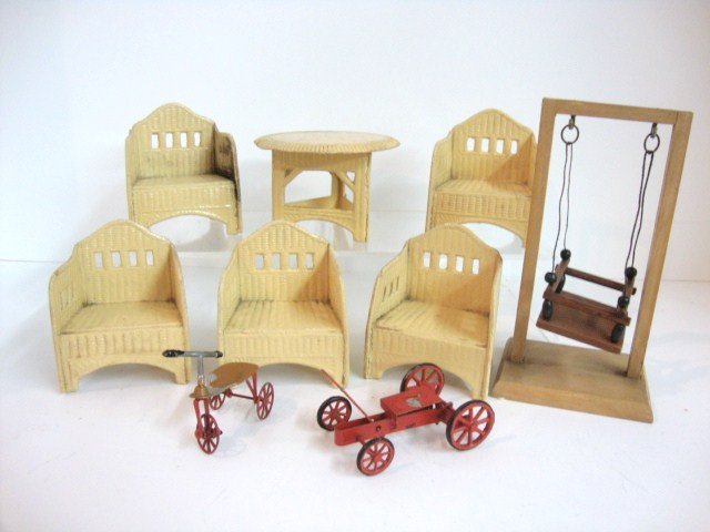 Schreiter Patio Furniture: Vintage pressed cardboard table and five chairs styled to look like wicker, plus a child's wooden swing, a small metal tricycle and go-cart, and a composition dog (damaged) 5 5/8".