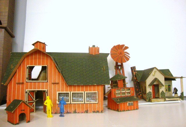 Cardboard Farm: American, as seen in the 1947 Sears Catalogue. Seven pieces include house, barn, silo, windmill, dog house and chicken coop. The barn is missing three doors, the barn's cupola is missing its cardboard