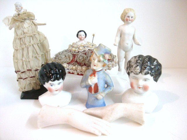 Lot of Miscellaneous Dolls/Parts: Lot consisting of 7 Items: 4" Frozen Charlotte, Blonde Parian, 5.5" Doll w/Parian head, wrapped wire arms & legs on wood base, no wig, 3.5" Half Doll made in Japan, China Head on Pin Cushion (head 1",