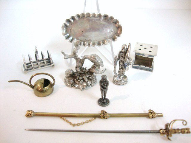 Vintage British Sterling: A sterling toast rack and platter 2" with hallmarks worn down, unmarked footwarmer, three cast metal figurines, a brass watering can and sheathed sword 3.5" L.