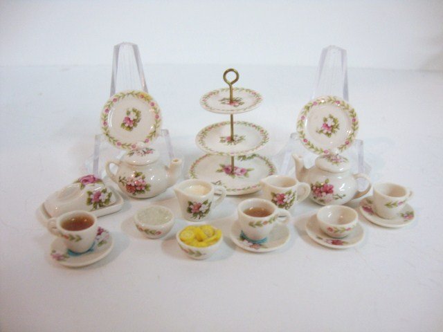 Avon Rose Pattern Tea Service: British porcelain tea service comprising a delicate three-tiered cake stand just under 1.5" H, two teapots, cream and sugar, four cups and saucers, covered cheese plate, bowl of lemons, 18 pieces.