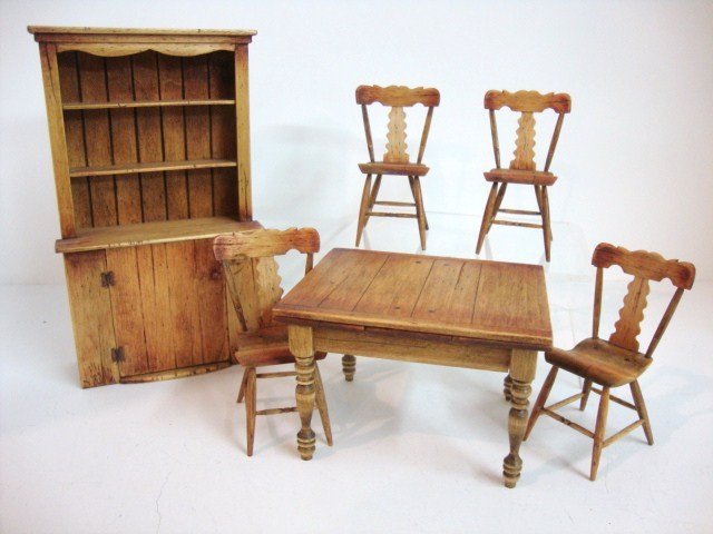 Cindy Malon Dining Group: Lovely pine finish step-back cupboard 6" H, 3.5" W by Cindy Malon, an extension table and four farmhouse plank seat chairs with the same finish, wonderful set.