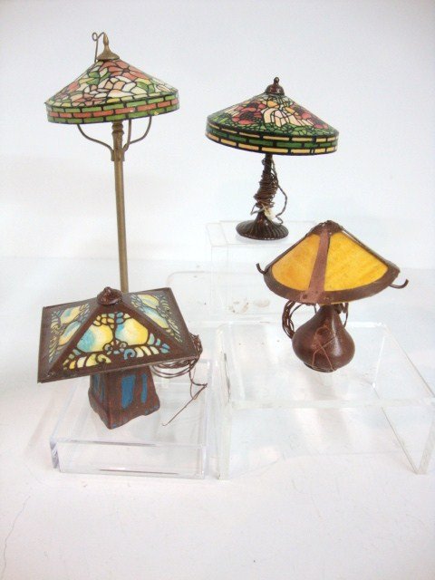 Kummerow Tiffany Lamps: Four stained glass Tiffany-style lamps by the Kummerows including a floor lamp 5" H and three table lamps: two with intricate stained glass shades and one with amber slag glass, all electrified.