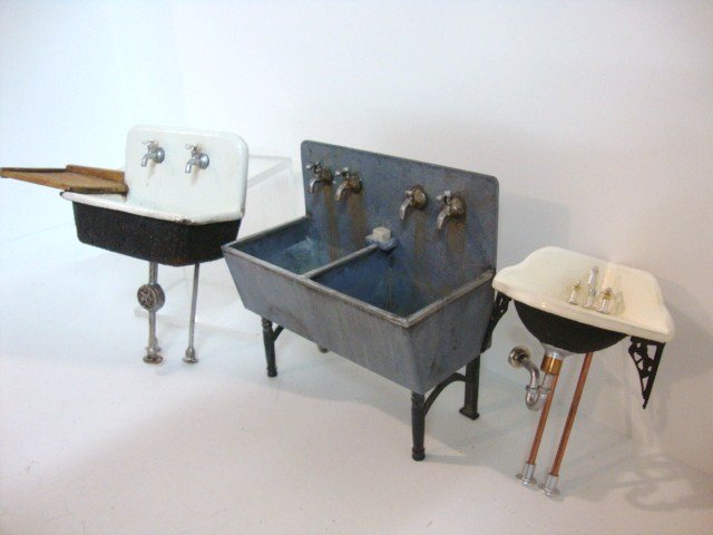 Betty Blankenfeld Sinks: A trio of superbly styled and crafted sinks by Betty Blankenfeld: a utility room double sink 4" H and W, a "cast iron" kitchen sink with drainboard and an elegant lavatory corner sink.