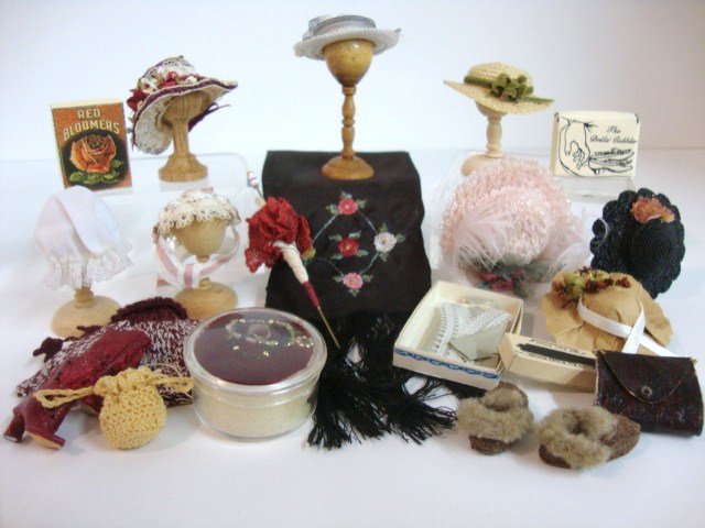 Lady's Wardrobe: Assortment of hats and hat stands, gorgeous embroidered shawl by Linda Driscoll 7" L plus fringe, parasol, gloves, etc. Also two pairs of shoes by Sylvia Rountree, the Dolls' Cobbler.