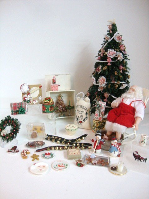 Santa Sleeps It Off: A snoozing Santa doll soaking his feet 4" H beside a beautifully decorated Christmas tree 8" H with a few holiday-related accessories.