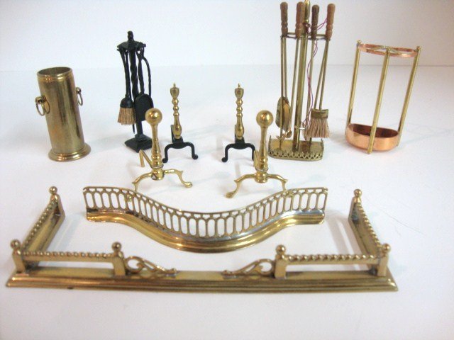 Brass and Iron Fireplace Tools: Two brass fireplace fenders, the larger 4.5" L, brass and copper umbrella stands, andirons, spittoon, and two sets of fireplace tools.