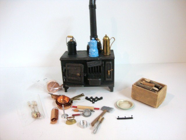 Victorian Kitchen Things: A very detailed and heavy cast iron stove of the type found inserted in English fireplaces 3" W and H plus an assortment of accessories including copper pots and pans.