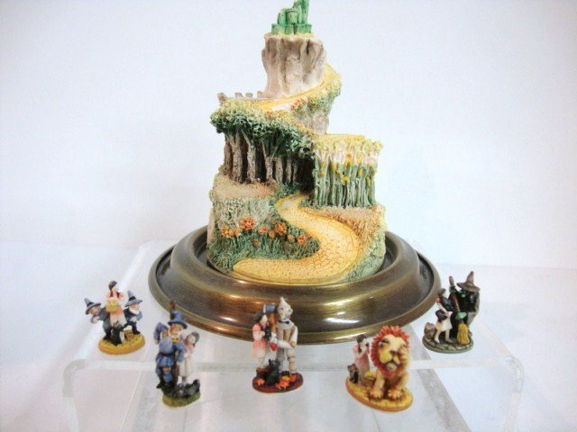 Olszewski Goebel Wizard of Oz Figurines: Five figurines from the Wizard of Oz with 942-D yellow brick road display stand and globe: 3705-3 Wicked Witch, 37054 Dorothy and Munchkins, 37050 Scarecrow, 37052 Lion and 37051 Tin Man 1" H, origina