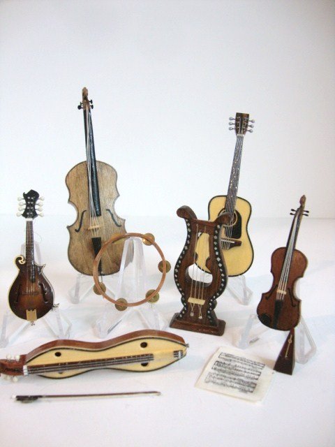 Musical Instruments: Large assortment of artisan and commercial musical instruments comprising a violin and cello 4" L both by Harold Goldman, guitar, dulcimer, lyre, tambourine and metronomes. Nice lot.