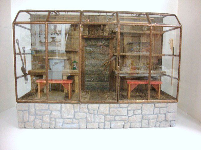 Lady Jane Potting Shed: Artisan wall-hanging pottery shed encased in leaded glass over faux stone foundation, electrified terrarium and lantern and assortment of garden tools included. 17" L, 13" H, 6" D