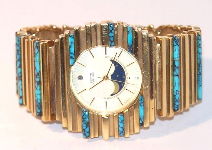 18K Arthur King Seiko Watch with Turquoise: Attributed to Arthur King 18Kt. Watch band with Seiko watch set in. 10" long. Turquoise Accents on Band. Weighs 170 grams